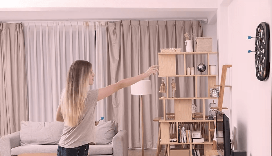 8 Best Electronic Dartboards for Interactive Fun 2 A picture of someone playing a wall-mounted electronic dartboard.