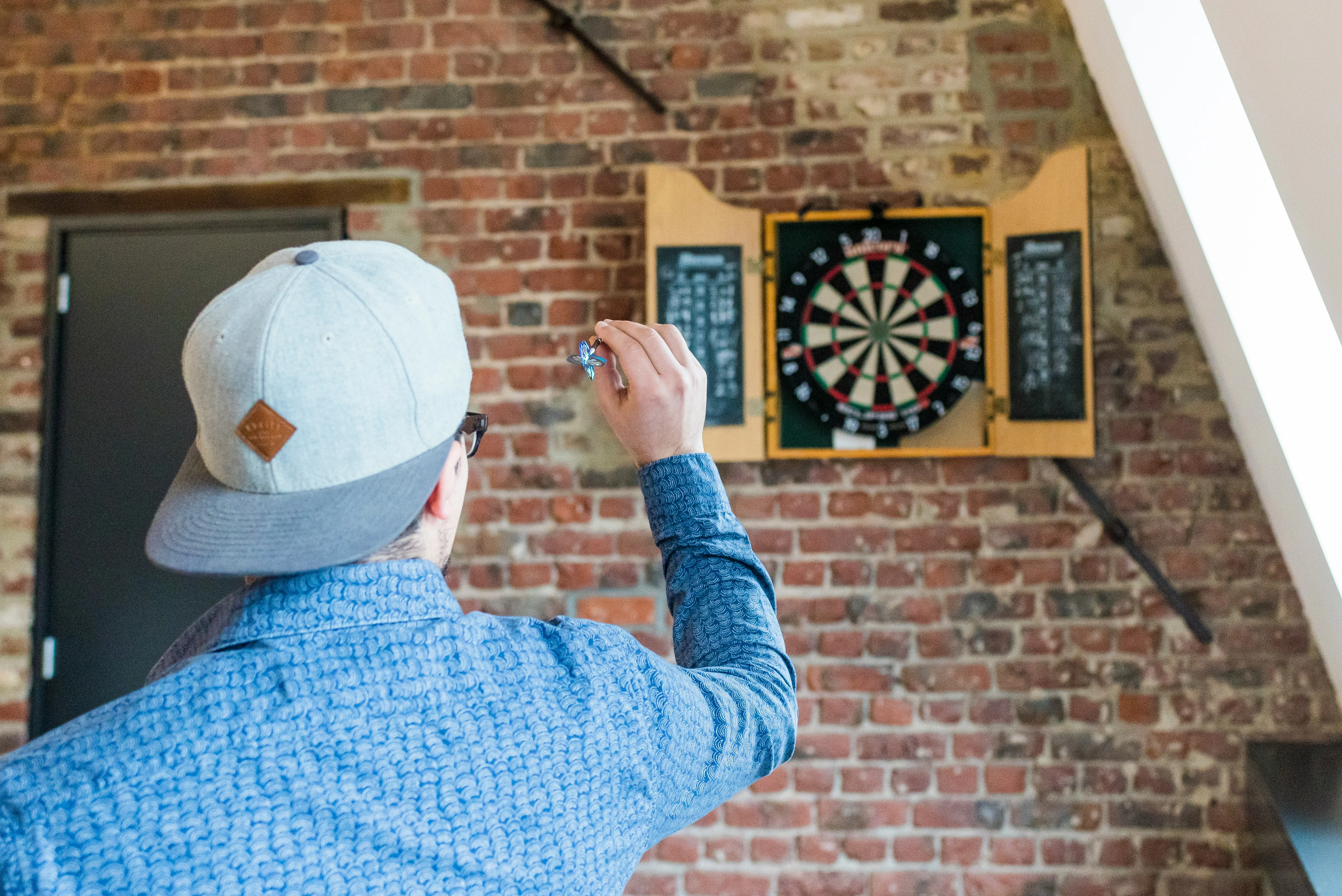 A photo of someone practicing darts at home.