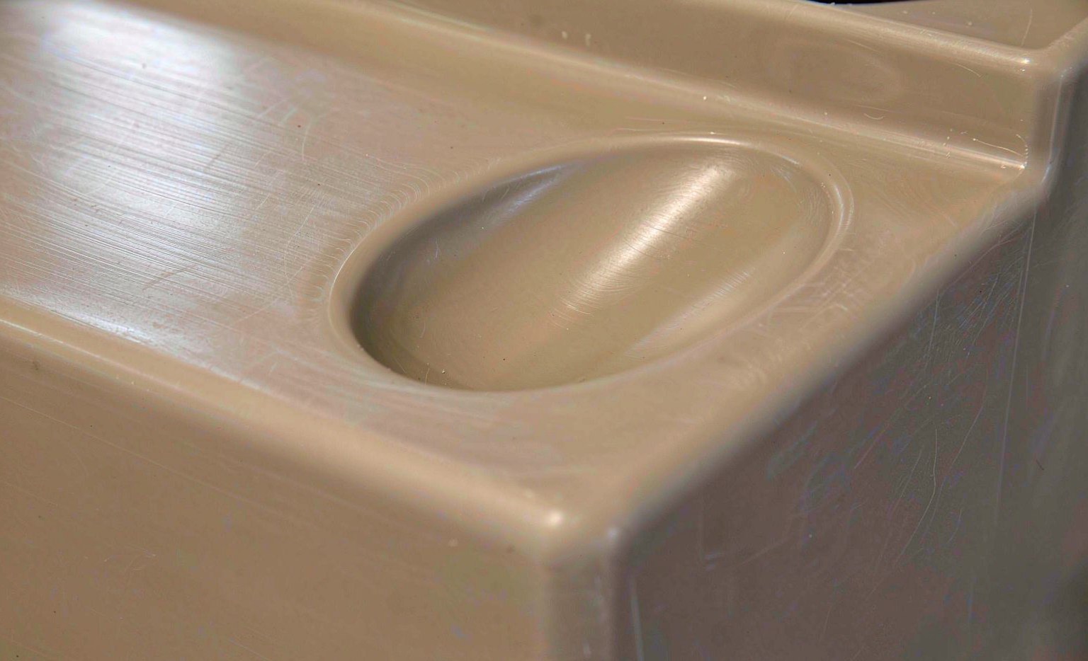 Sink mark depression on a thick molded plastic section