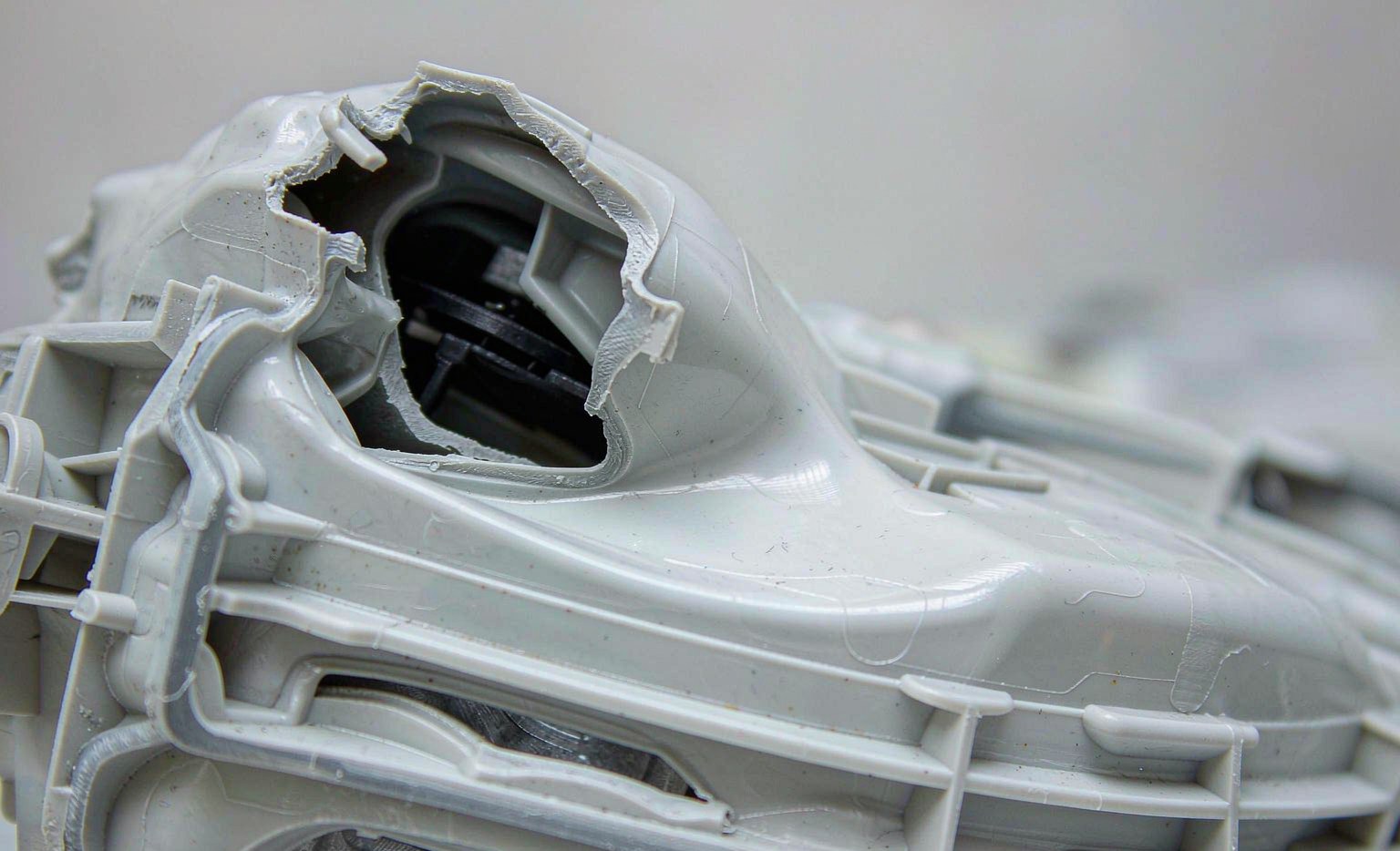 Incomplete short-shot molded part missing a section