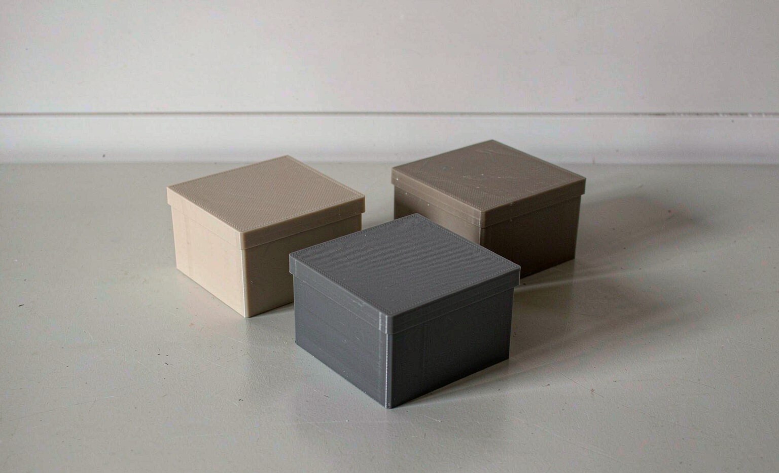 Three molded resin samples PP ABS PC side by side