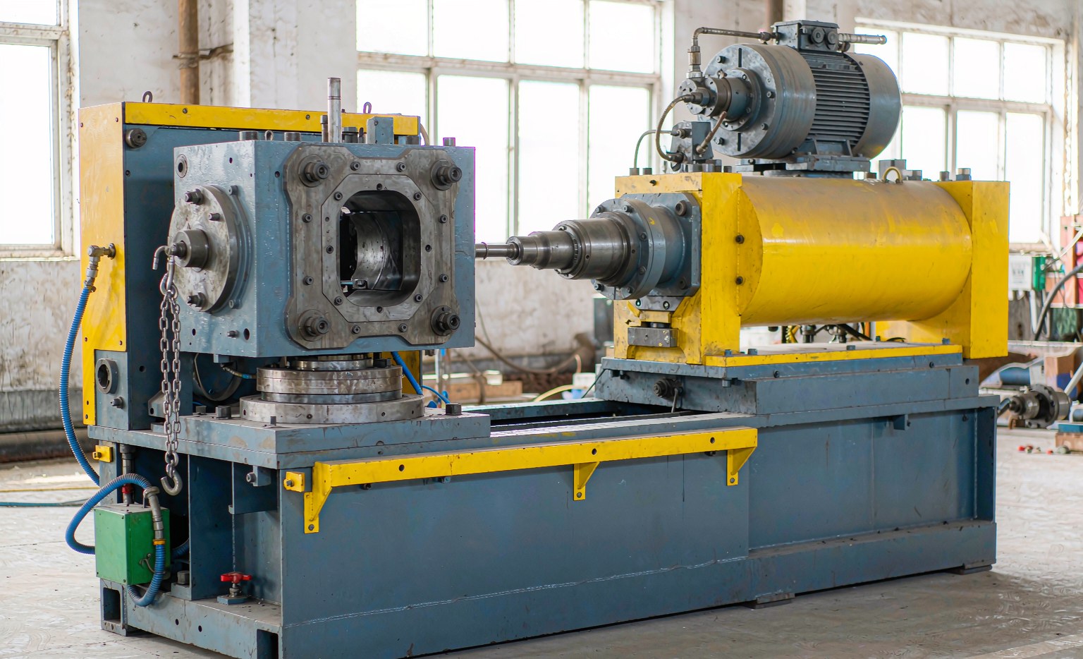 Plastic injection molding machine with clamping unit on a factory floor