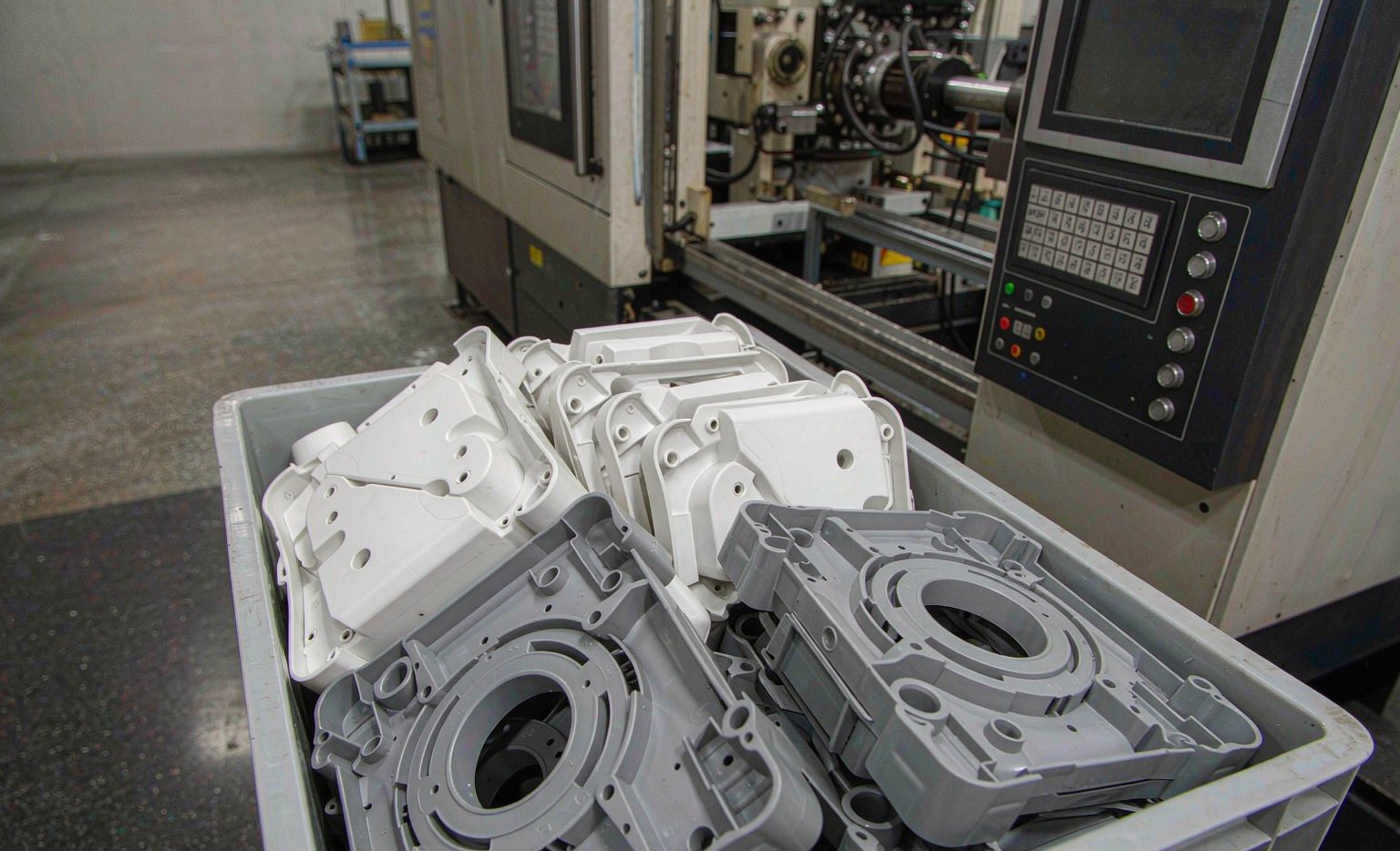 Freshly molded engineering plastic parts in a bin