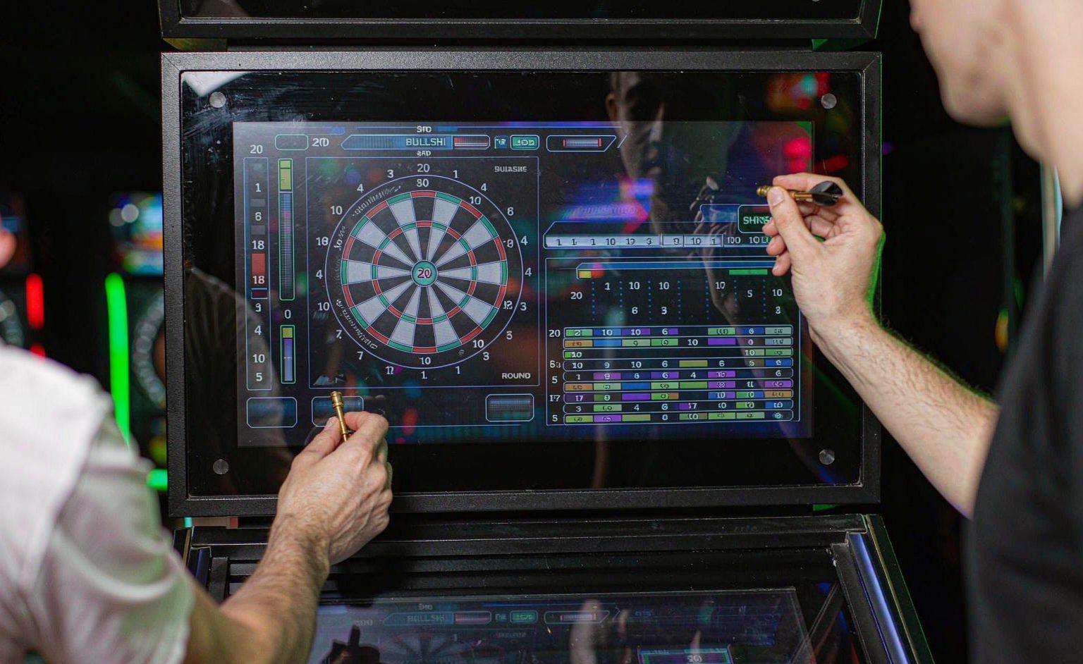 Coin operated electronic dart machine cabinet in a game room with colorful lighting