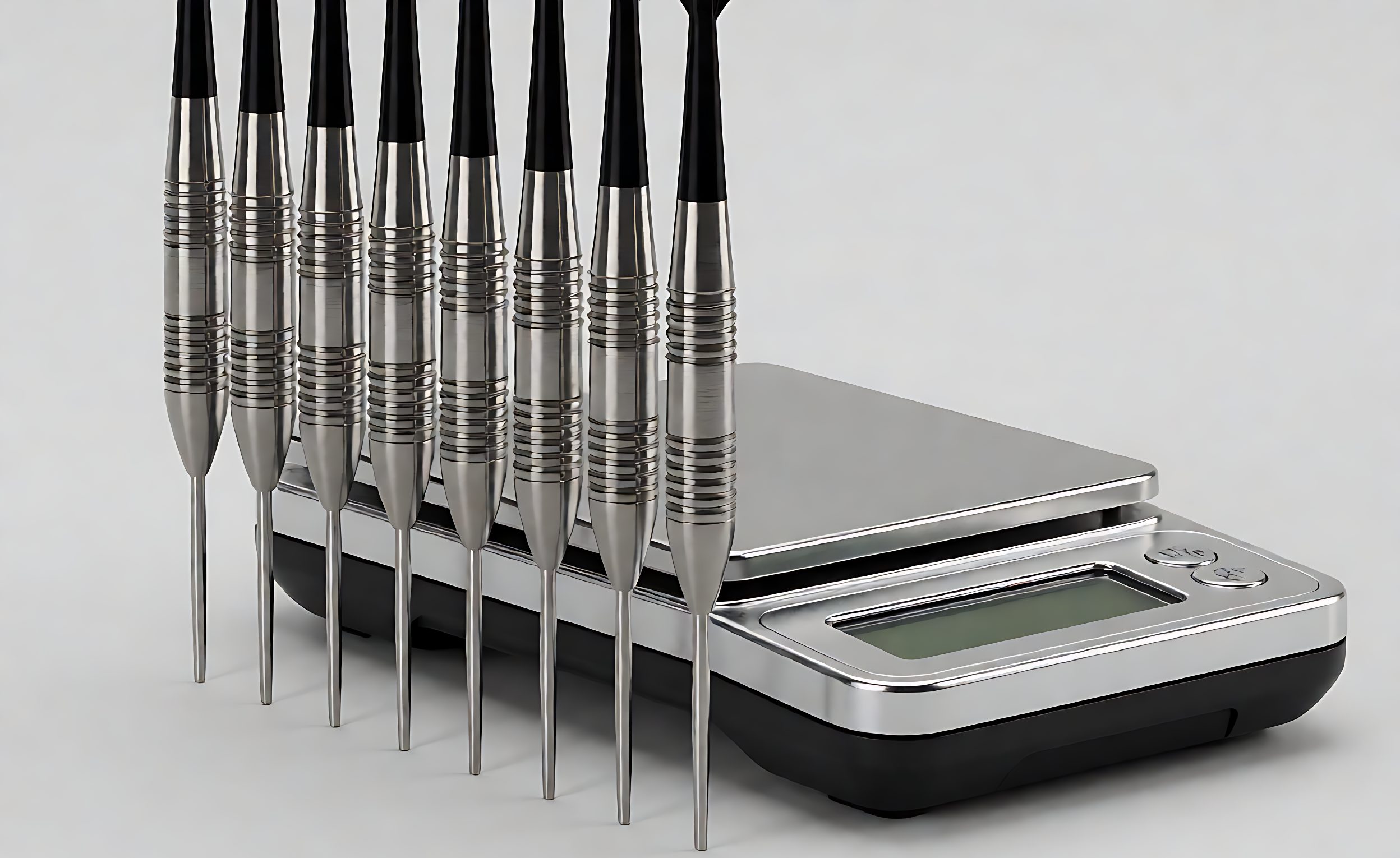 Steel-tip darts standing upright beside a digital precision scale