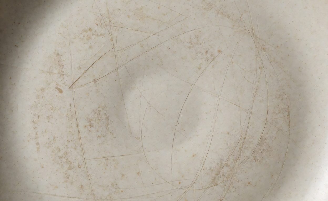 Surface wear on a used plate Plate surface showing scuff marks and wear after use
