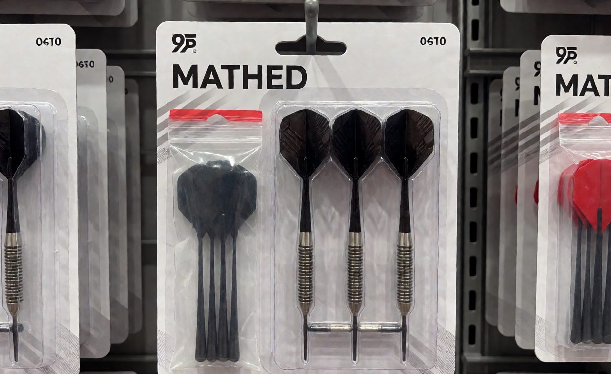 Retail blister card with a matched set of three darts and a bag of spare shafts and flights